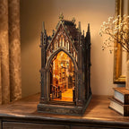 Aleph Library miniature Gothic library displayed beside a vase of dried flowers.