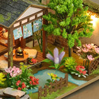 Bamboo Spring Courtyard garden with a pavilion, tiny bridge, trees and flowers.