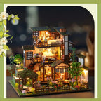 Bamboo Spring Courtyard miniature house illuminated against a dark background.