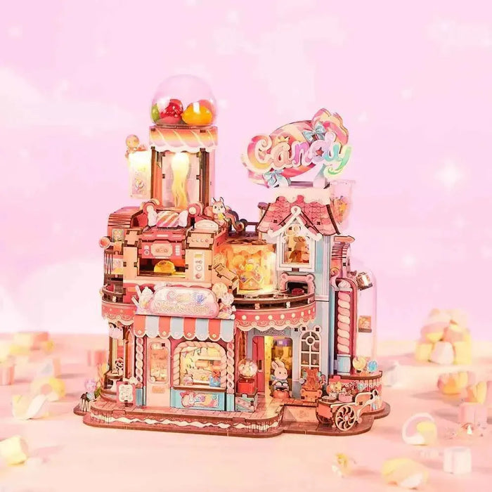 Candy Workshop pink miniature factory with a candy dispenser, striped awnings and a candy sign.