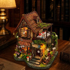 Angled Dreamy Cottage showing its tiled roof, upper terrace and rose-lined steps.