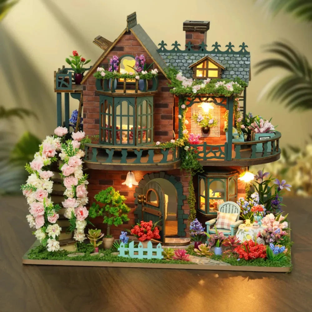 Fairy Garden miniature house with green balconies, warm-lit rooms and flowering vines.