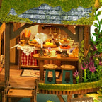 Forest Adventure miniature dining area with a green table and warm lights.