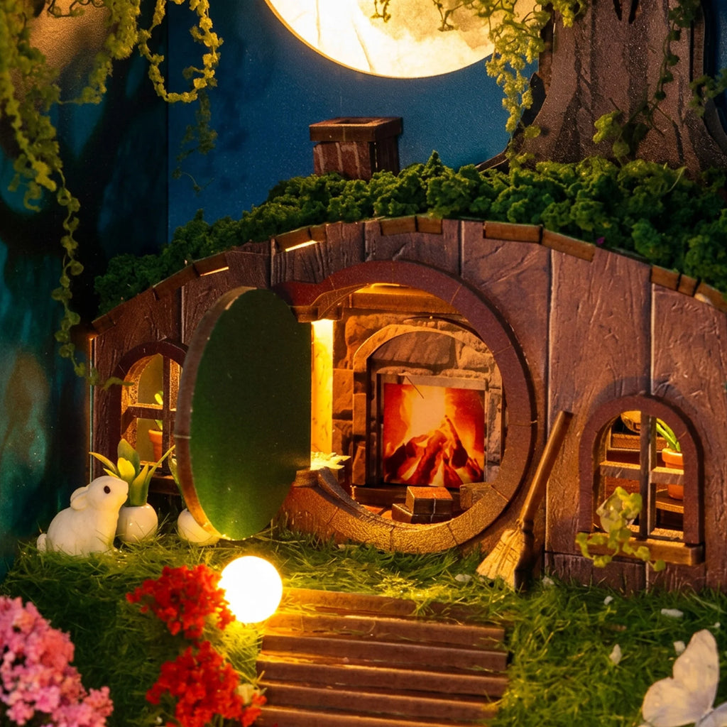 Hobbins Hovel round doorway revealing the warm fireplace inside the miniature cottage.