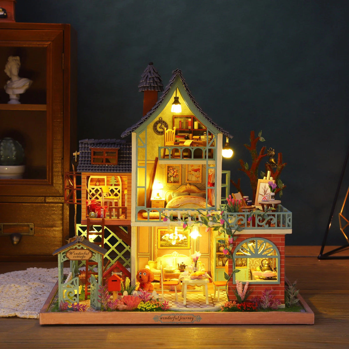 Jungle Secret miniature house with tall open rooms, balconies and warm lights.