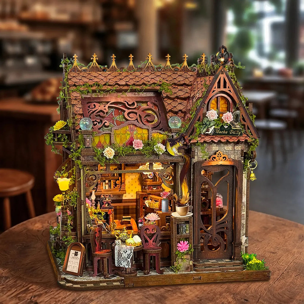 Front view of Mocha Diary on a wooden table, with illuminated café windows.