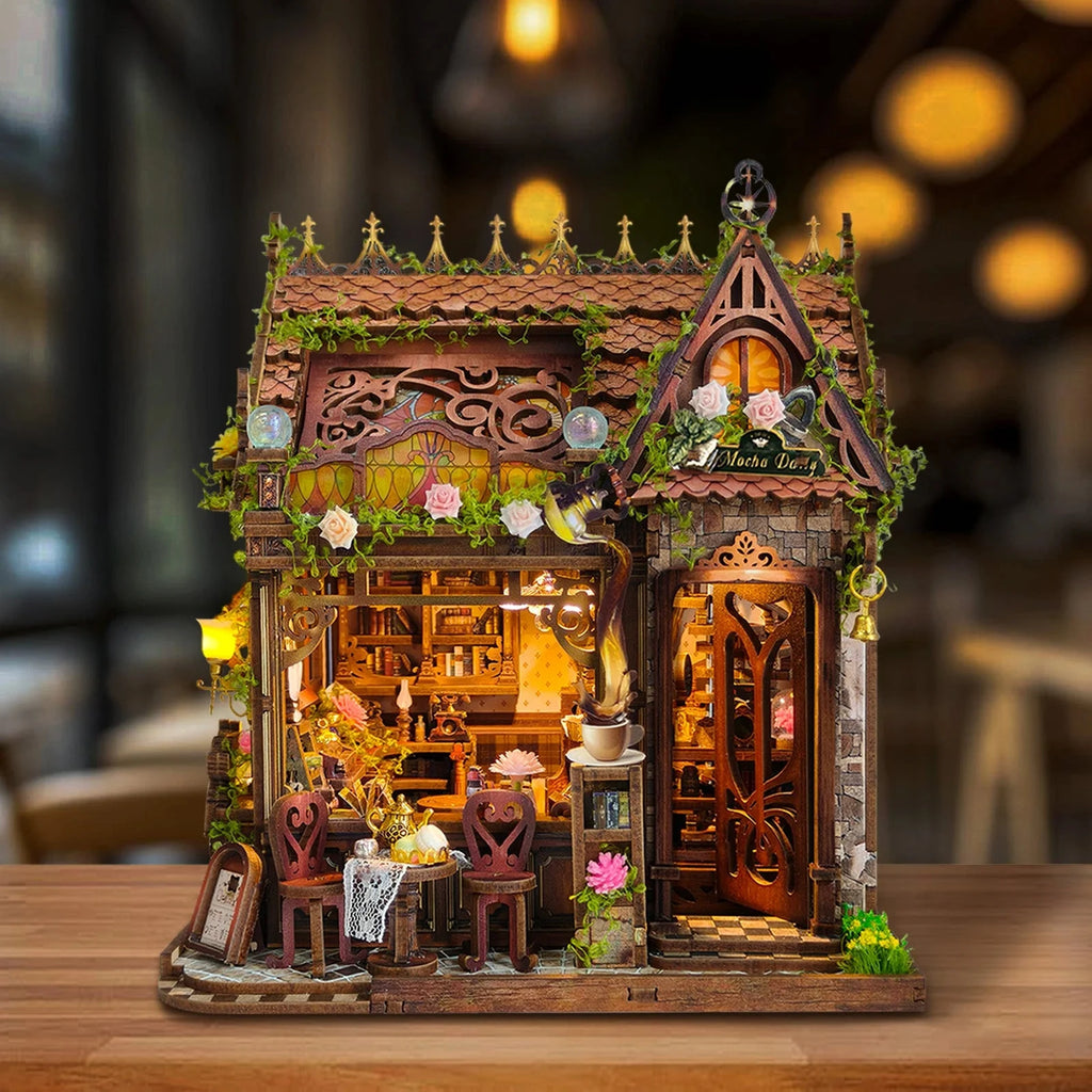 Mocha Diary miniature café with floral trim, an ornate roof and a small outdoor tea table.