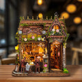 Mocha Diary miniature café with floral trim, an ornate roof and a small outdoor tea table.