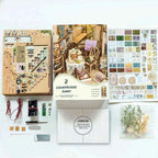 Pastoral book nook kit contents with wooden panels, printed decorations, lighting parts and instructions.