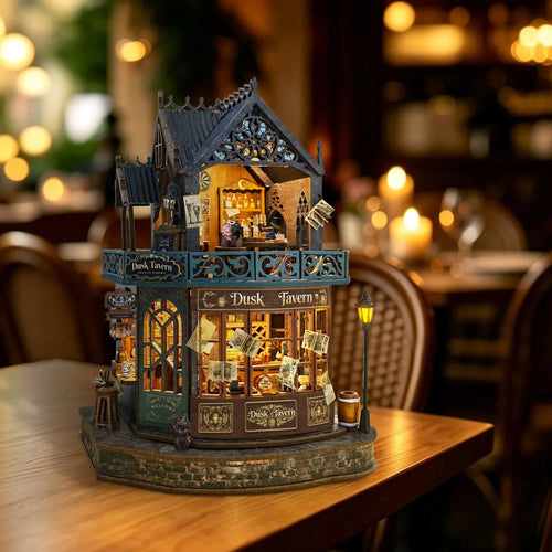 Twilight Tavern miniature pub with a blue upper balcony and warm-lit curved windows.